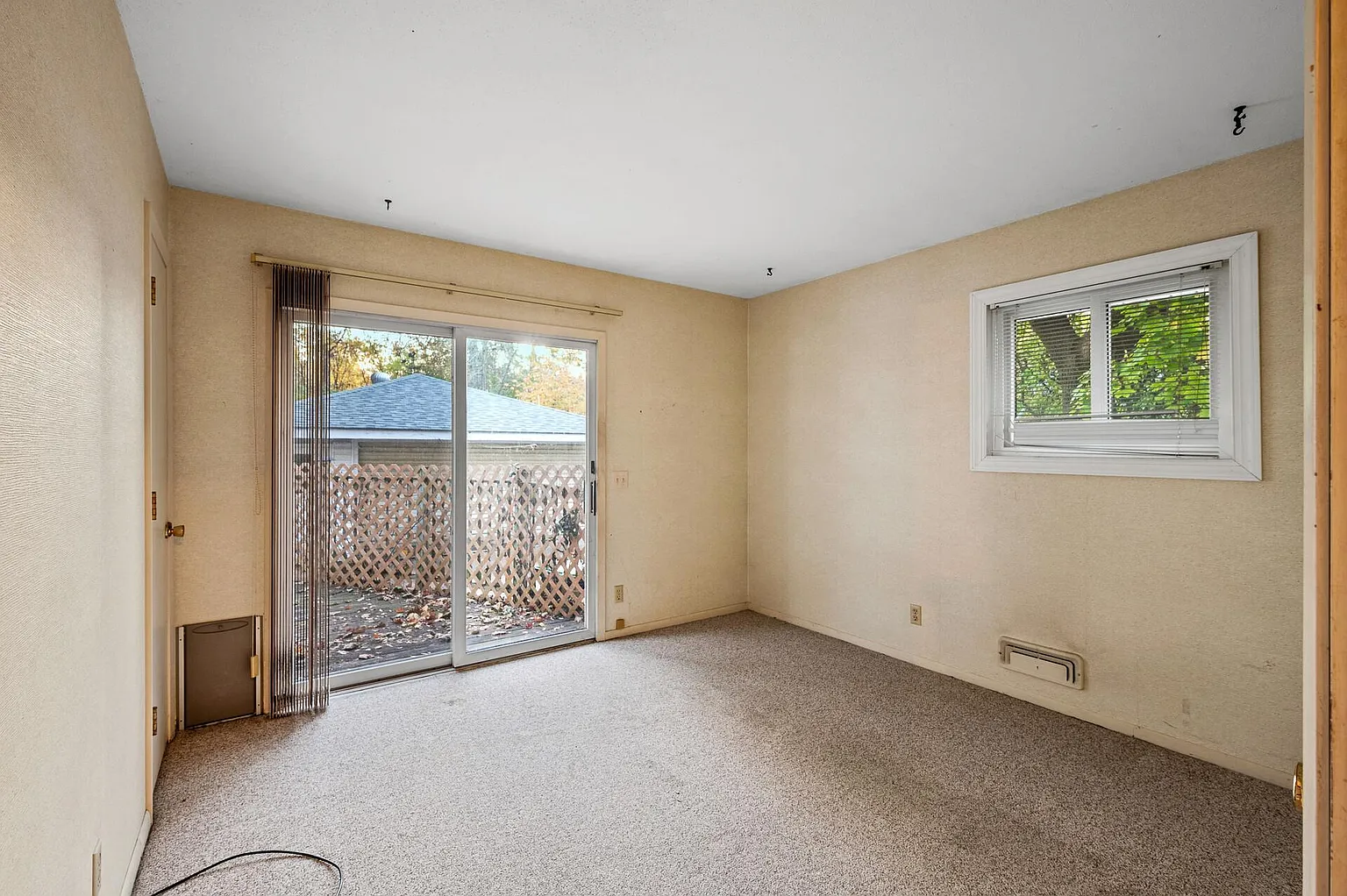 Private bedroom with neutral walls and soft carpeting