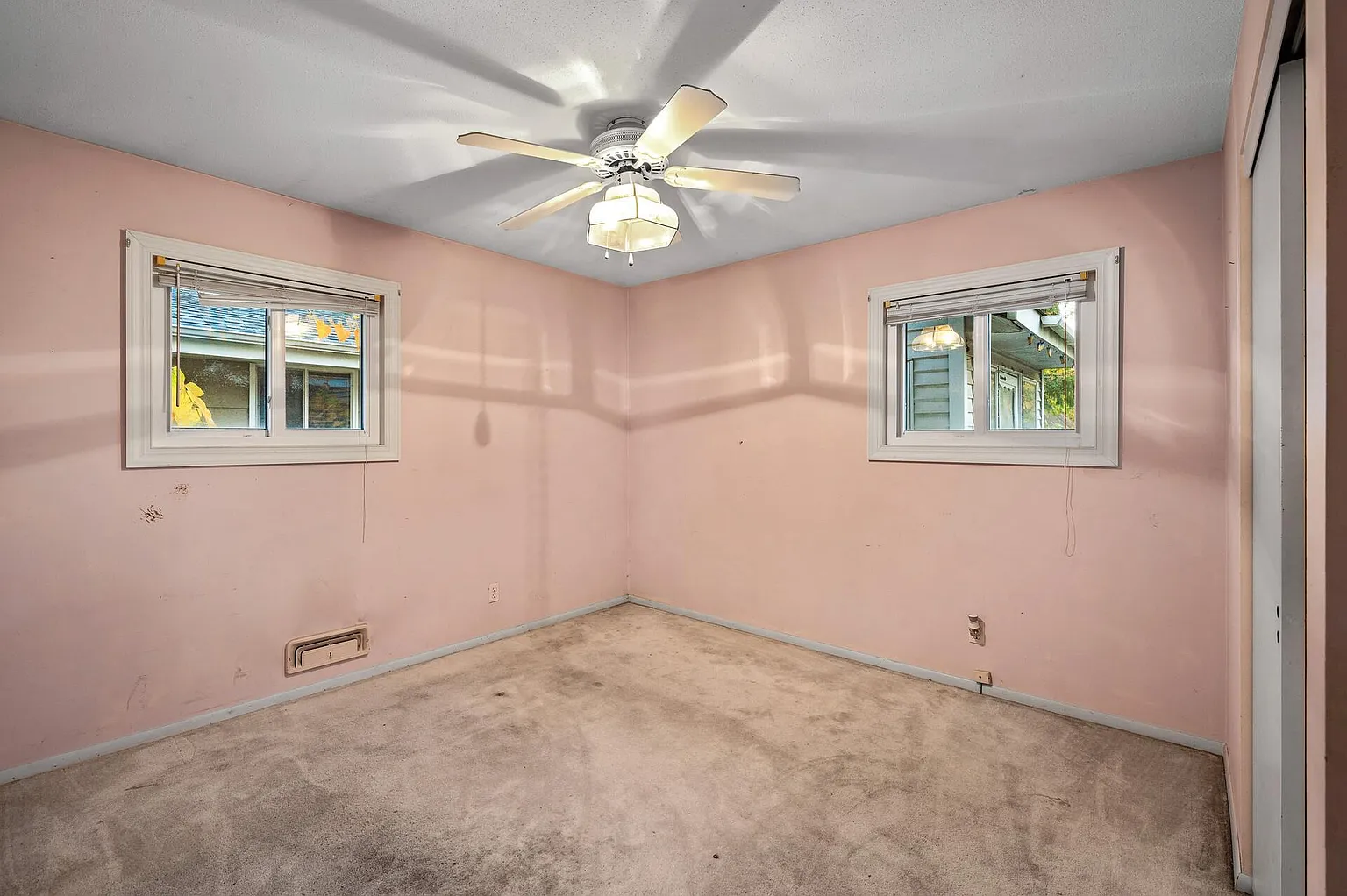 Private room with three windows and a ceiling fan