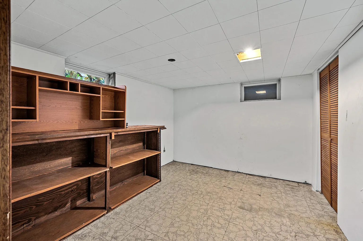 Lower-level room with built-in shelving and desk space